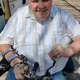 Hands-on wheelchair seat  adaptive fishing rod holder with manual reel-quadriplegic man Mark felling in wheelchair on dock